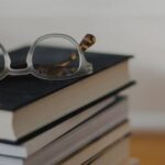 A pile of books with a pair of spectacles on top